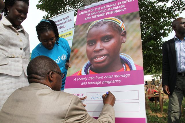Hon. Muruli Mukasa, Minister of Gender Labour and Social Development officially launches the "National Strategy to End Child Marriage and Teenage Pregnancy," at the Day of the African Child 2015 commemoration event in Bbaale Sub-county, Kayunga District