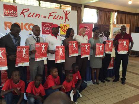 Sponsors, some members of Kids of Africa and their management pose with banners for November 8th Run for Fun