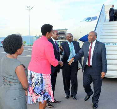 PM Rugunda(R) received by Ambassador Kabonero (2nd R) and other officials on arrival at Kigali international Airport on Tuesday