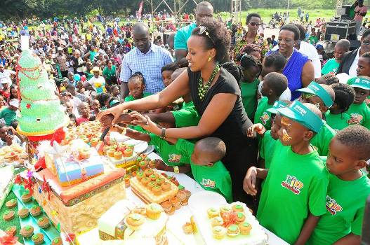 Natasha Karugire cutting cake with kids on Sunday at Kololo Airstrip