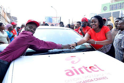 Ian Bukenya the first lucky winner of the Mujje Tulumbe Consumer promotion recieves a car key from Airtel Uganda Head of Brand and Communications Remmie Kisakye