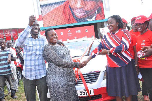 Rita Nabuzale being congratulated by Airtel's Remmie Kisakye,Head of Brand and Communications on her win of a brand new car