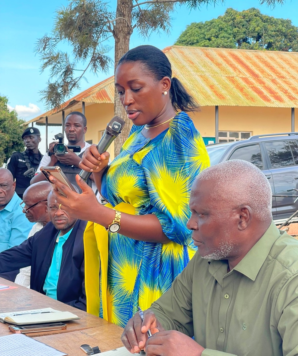 Justine Nameere listens as Masaka City residents share concerns about PDM